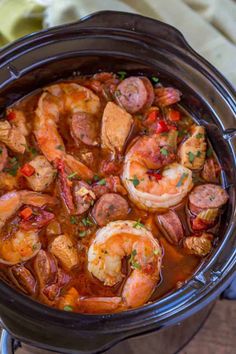 a crock pot filled with shrimp and sausage stew