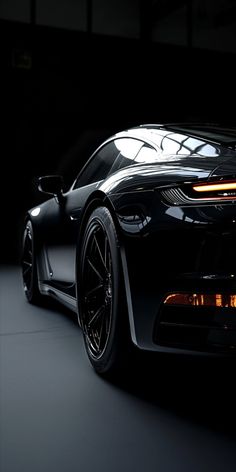 a black sports car is shown in the dark