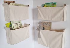 two white storage bins with books and magazines hanging on the wall next to each other