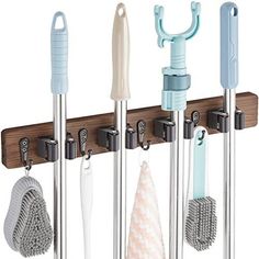 a rack with several different types of cleaning tools hanging from it's sides and hooks