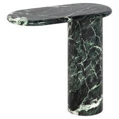 a black and green marble table with an oval shaped design on the top, sitting against a white background