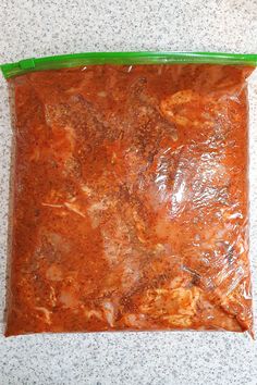 a bag of food sitting on top of a counter next to a green plastic container