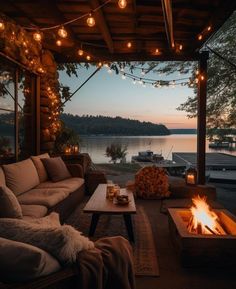 a living room with a fire pit and lots of lights