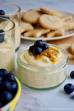 two desserts with blueberries and crackers on the side