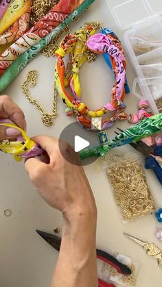 a person is making bracelets with scissors and other crafting supplies on a table