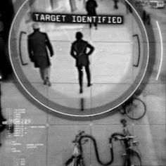 two people standing in front of a target sign with bicycles parked on the sidewalk behind them