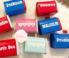 six personalized candy boxes with hearts on them sitting on a white furnishing