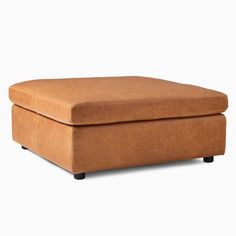 a brown ottoman sitting on top of a white floor