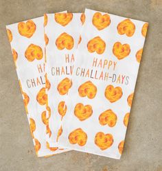 three napkins with orange designs on them that say happy chalw challa - days