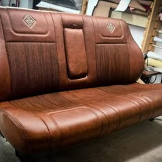 two brown leather seats sitting next to each other