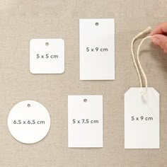 four tags are shown with the measurements for each piece of paper on them, and one is