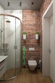 a bathroom with brick walls and wooden floors