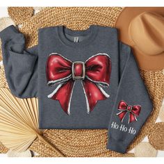 Get into the festive spirit with our cozy sweatshirt featuring a charming coquette Christmas bow, complete with personalized sleeve text! 🎀🎄 This stylish and comfy sweatshirt is perfect for the holiday season, combining a festive design with a personal touch. Whether you're out spreading holiday cheer or staying warm by the fire, this sweatshirt is a holiday must-have. 🌟 Personalized Just for You: Customize the sleeve with any text--add your name, a holiday message, or a special date to make Red Bow Christmas, Christmas Coquette, Coquette Christmas, Bow Shirt, Holiday Messages, Bow Christmas, Bow Shirts, Christmas Bow, Festive Design