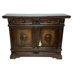 an old wooden cabinet with marble top