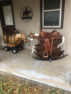 a horse drawn sleigh sitting on top of a cement slab next to a house