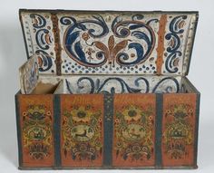 an old wooden box with painted designs on it