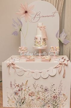 a table topped with a cake covered in frosting