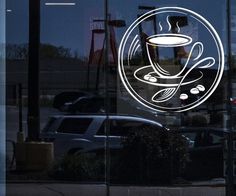 a glass window with a coffee cup and spoon on it