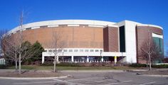 an empty parking lot in front of a large building