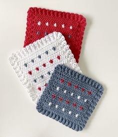 three crocheted dishcloths sitting next to each other