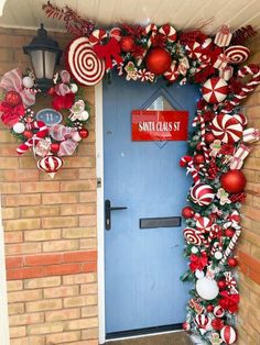 a blue door decorated with candy canes and christmas decorations