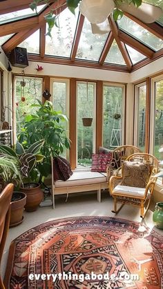 the sun room is filled with plants and furniture