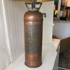 an old fashioned fire extinguisher on display in a store or office area