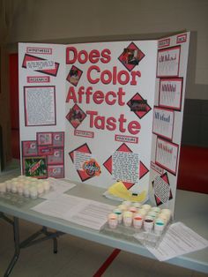 a table that has some cupcakes on it and a sign in the background