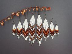 seed bead work with leaves on grey background