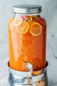 a mason jar filled with orange juice and sliced lemons