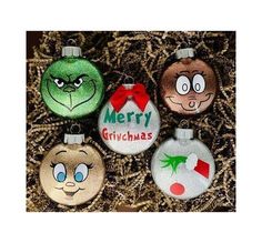 three christmas ornaments with faces on them