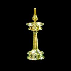 a golden candle holder on a black background