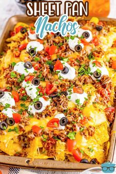 a sheet pan filled with nachos topped with eyes