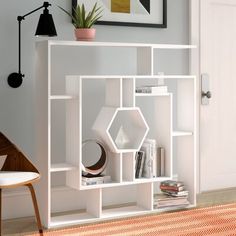 a living room with a white book shelf filled with books