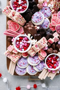 valentine's day treats are arranged on a tray with candy and marshmallows