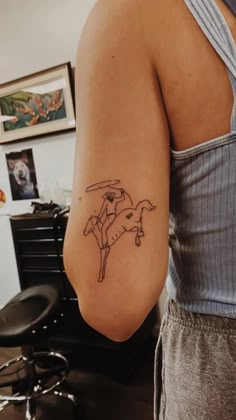 a woman with a cow tattoo on her arm