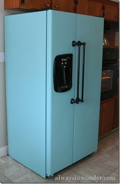 a blue refrigerator in the middle of a kitchen