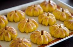 small pumpkins on a baking sheet ready to go into the oven