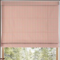 a window with an orange roman blind in front of it