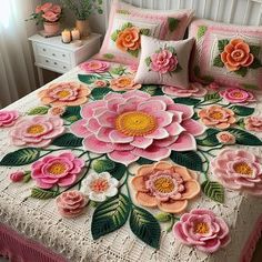 a bed with pink flowers and green leaves on it