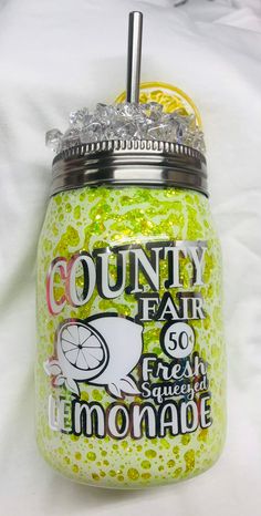 a jar that has some kind of fruit inside of it on a white sheet with the words, county fair go fresh and lemonade