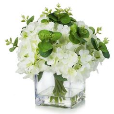 white flowers and green leaves in a square vase