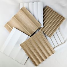 several different types of wood and white paper