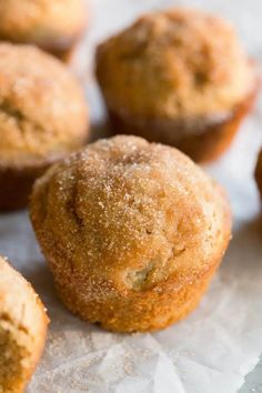 several muffins are sitting on top of some paper