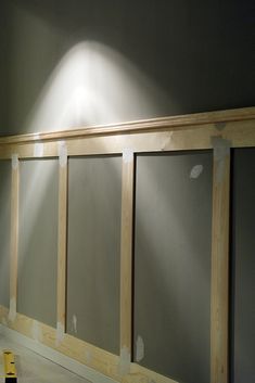 an empty room with three frosted glass doors on the wall and one light shining