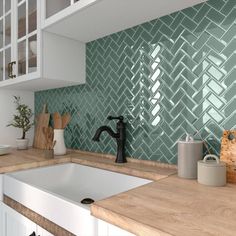 a kitchen with white cabinets and blue tile backsplashes on the wall above the sink