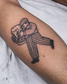 a man with a tattoo on his arm is holding a hot dog in one hand