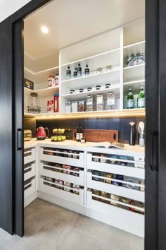 an open door leading into a pantry with lots of food