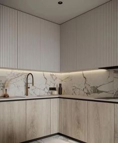 a kitchen with marble counter tops and wooden cabinets, along with a sink in the center