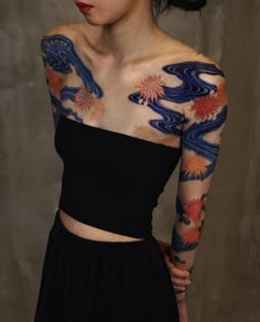 a woman with tattoos on her arms and shoulder